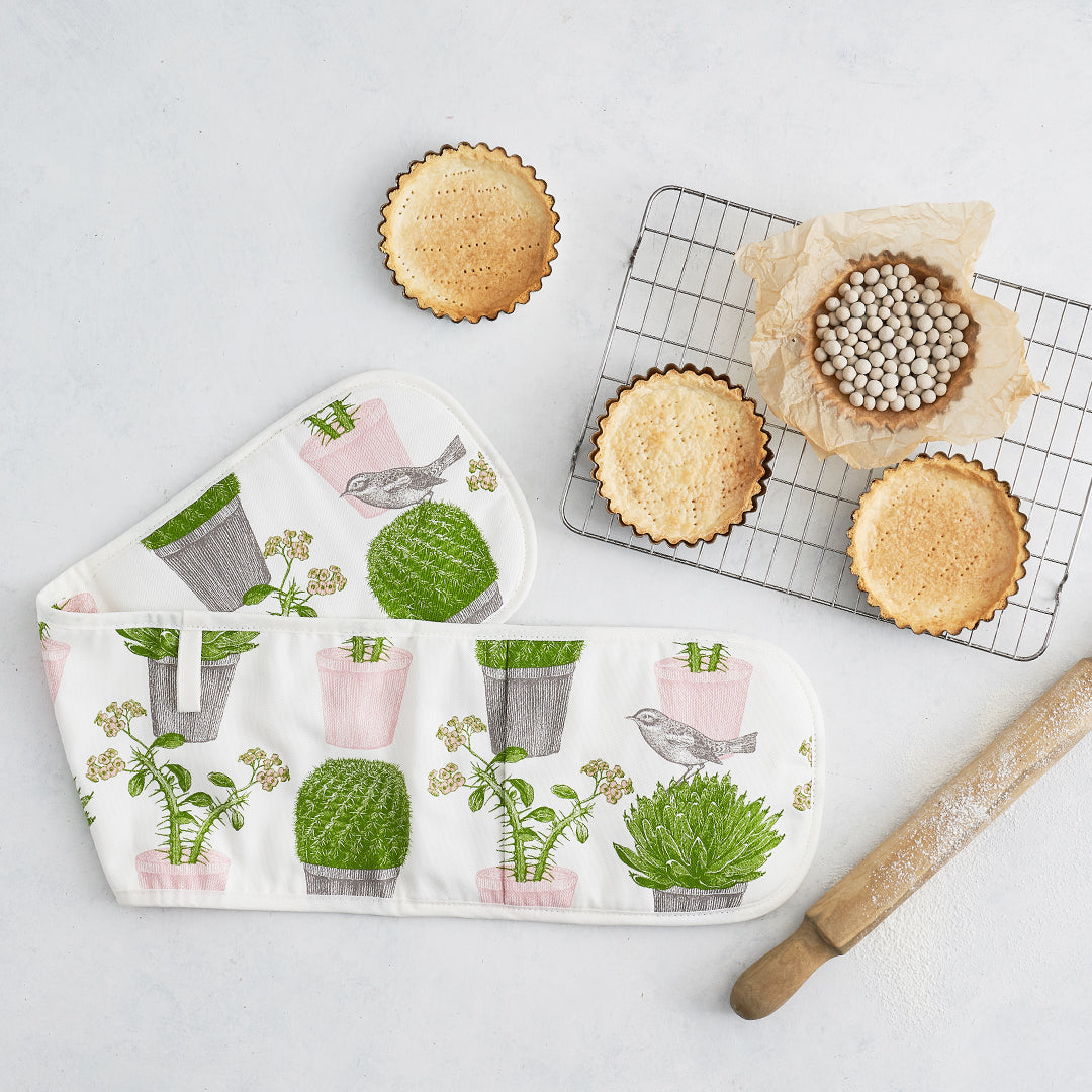 kitchentins - Thornback and Peel Cactus and Bird Cotton Double Oven Gloves Featuring pale pink and green potted succulents and a little bird hopping amongst them.