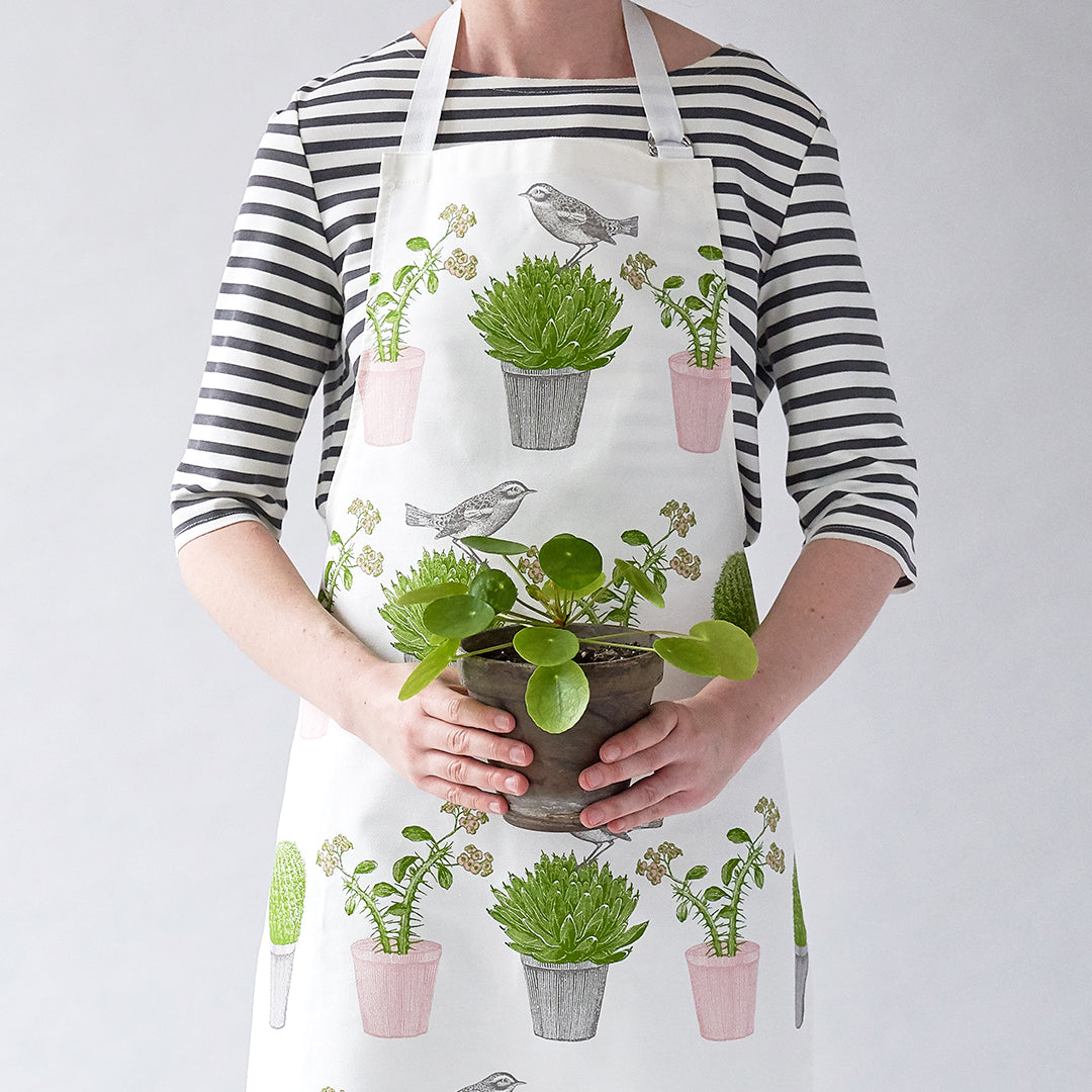 kitchentins - Thornback & Peel cotton apron printed with pink and green cactus and bird design with adjustable neck strap.