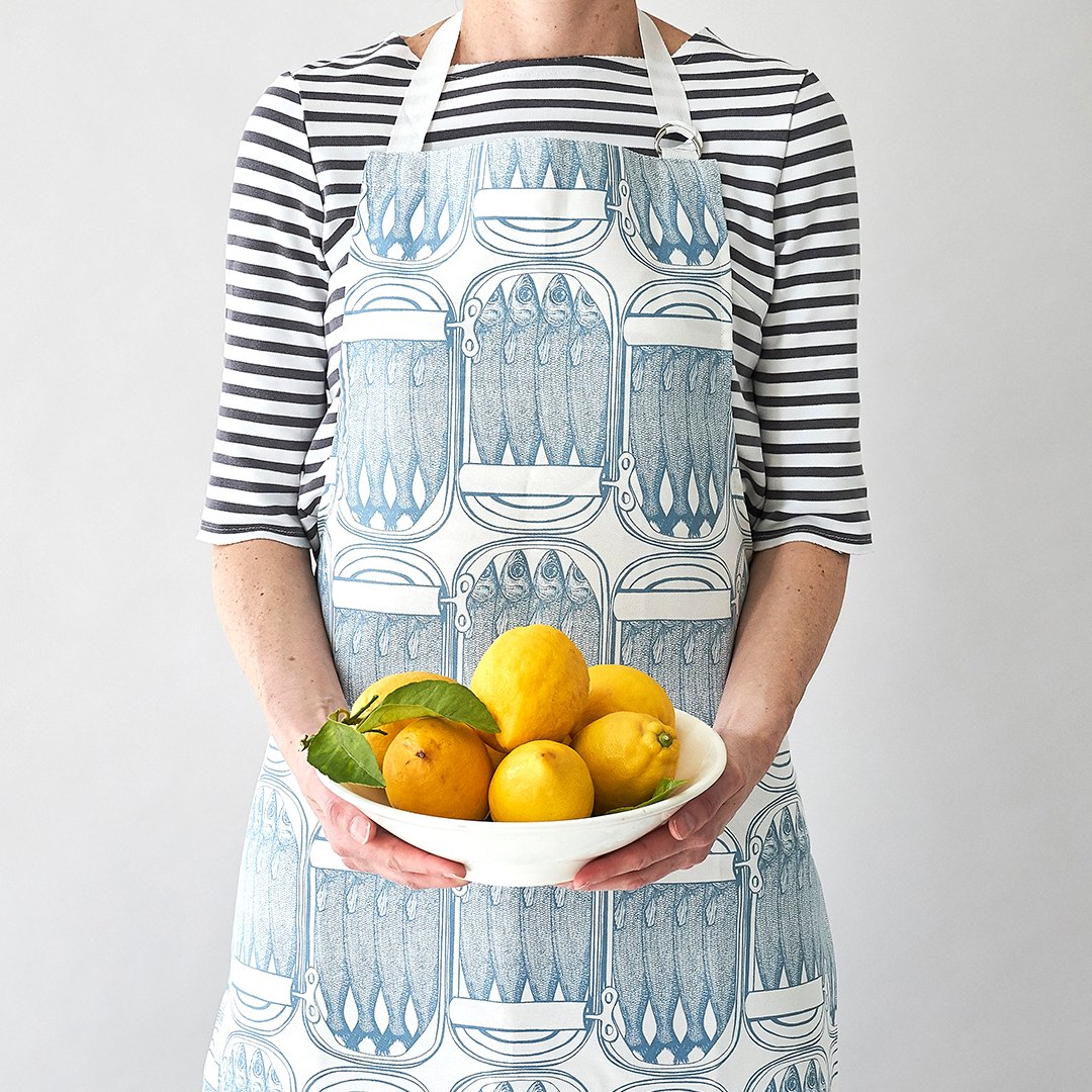 kitchentins - Thornback & Peel cotton apron printed with pale blue sardine tin design with adjustable neck strap.