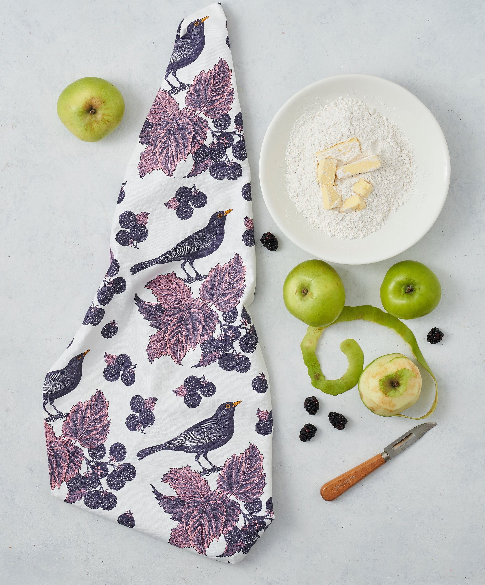 kitchentins - Thornback & Peel cotton tea towel printed with Blackbird and bramble design in purple tones.