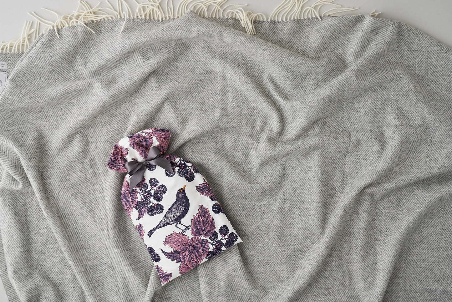 kitchentins - Thornback and Peel cotton hot water bottle cover printed with Blackbird and bramble design in purple tones.