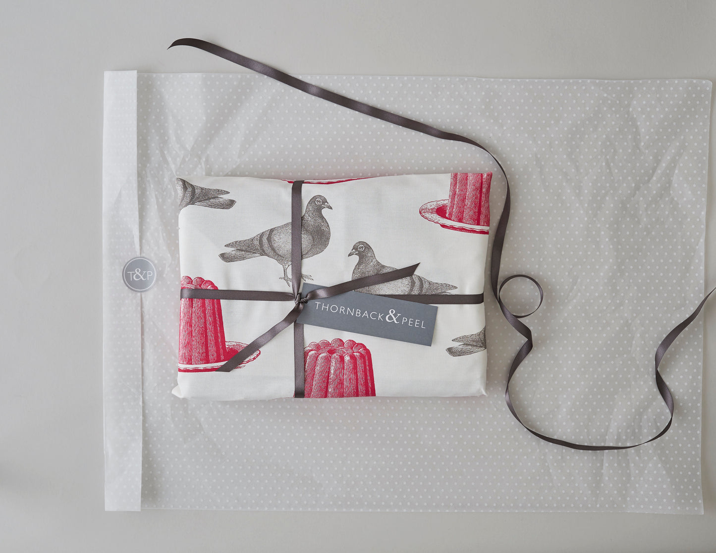 Kitchentins - Thornback & Peel cotton tea towel printed with raspberry pink jellies and grey pigeons.