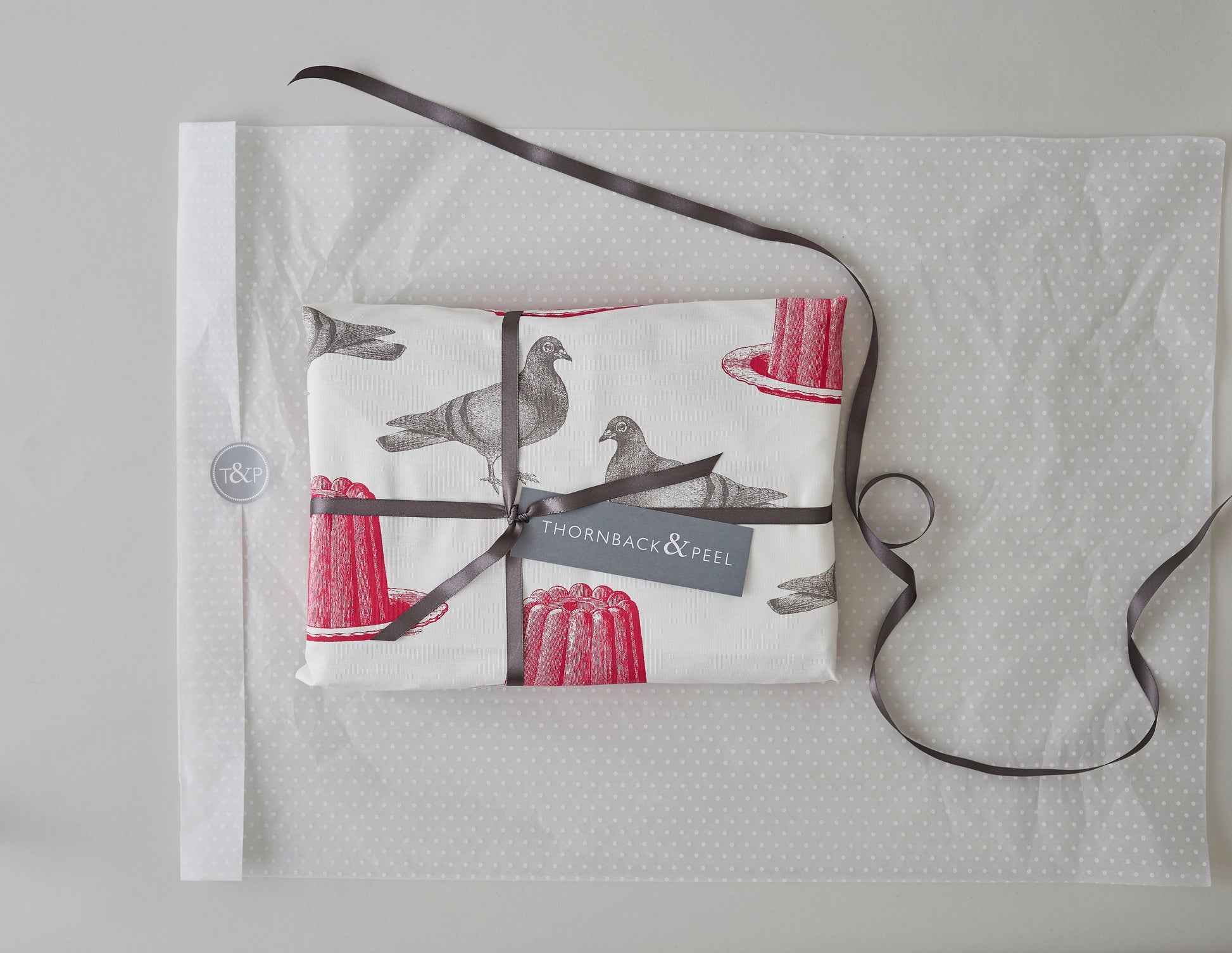 Kitchentins - Thornback & Peel cotton tea towel printed with raspberry pink jellies and grey pigeons.